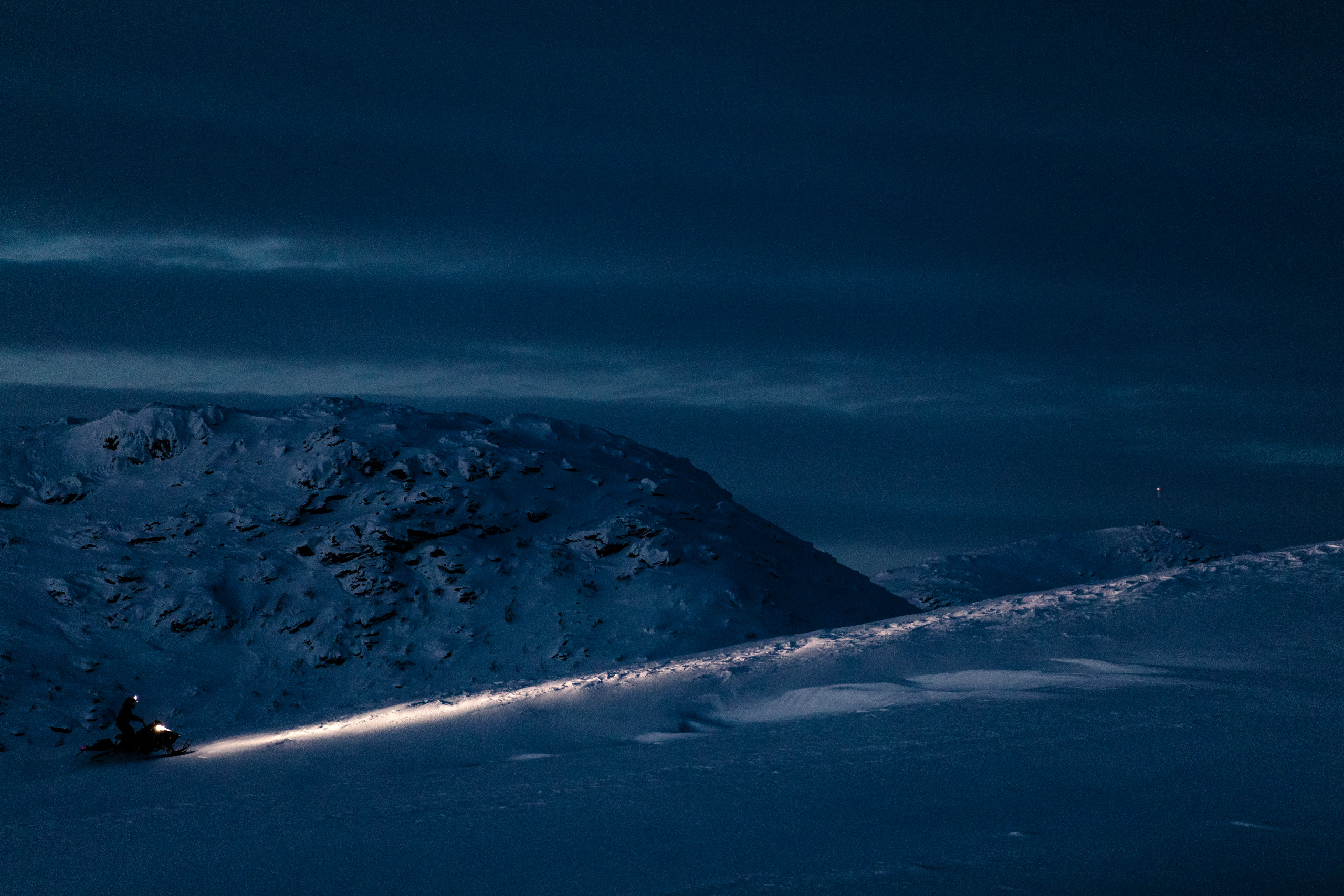 Snowmobile under northern evening sky in Gauto, Northern Scandinavia