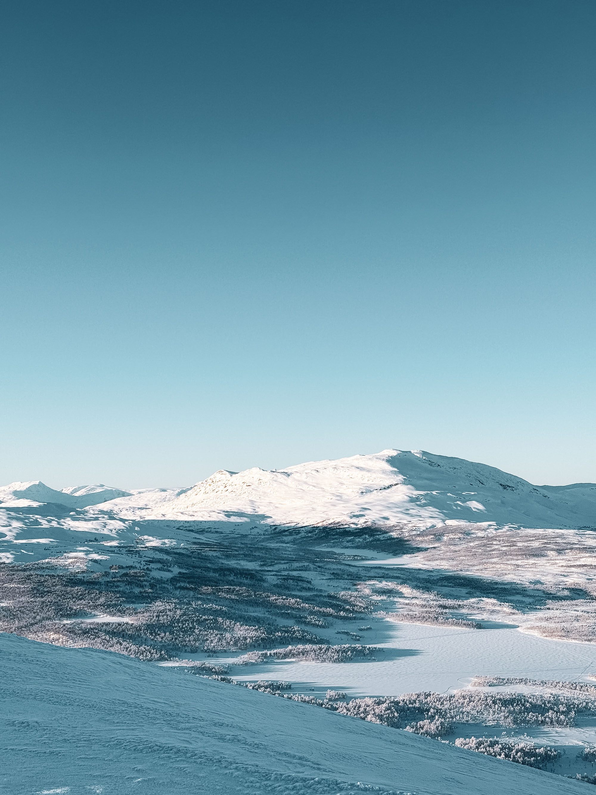 Open winter mountains and frozen lake in Hemavan